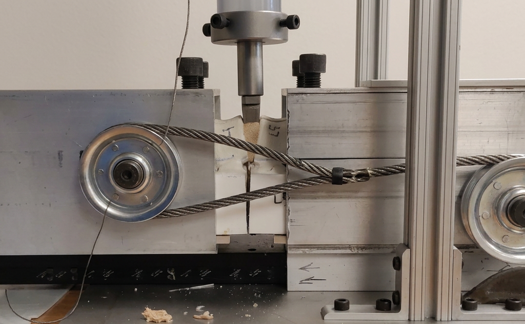 Custom drop-weight test setup: modular cage with potted bone model and cable-driven compressive loading